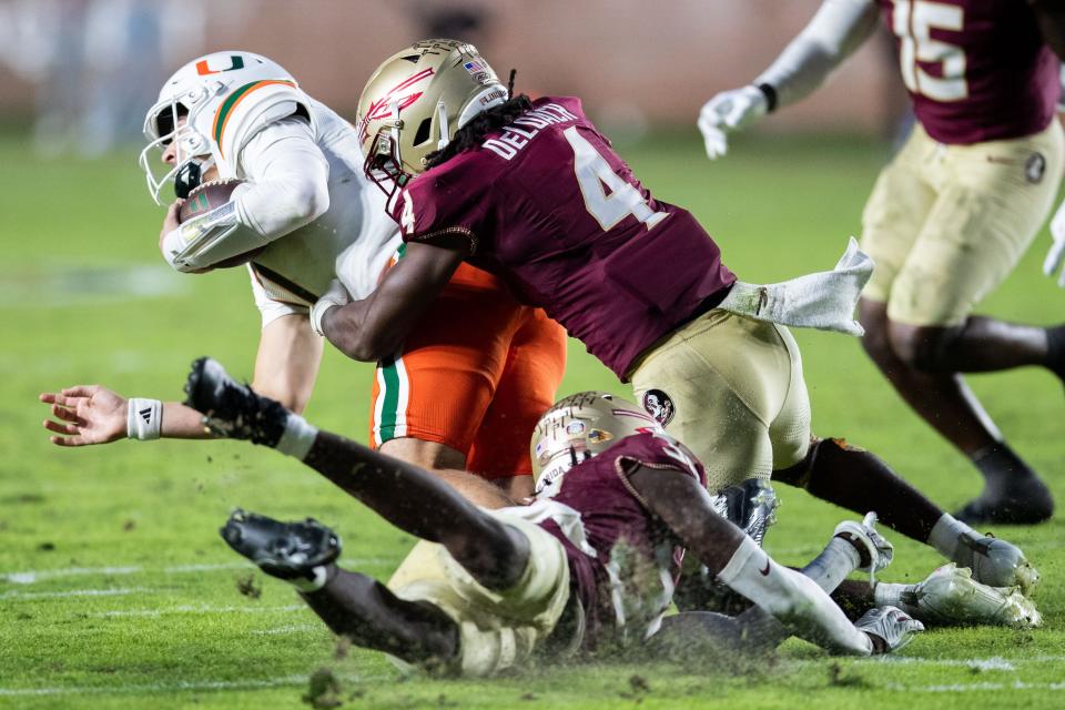 Florida State Seminoles linebacker Kalen DeLoach (4) tackles Miami Hurricanes quarterback Emory Williams (17)The Florida State Seminoles defeated the Miami Hurricanes 27-20 on Saturday, Nov. 11, 2023.