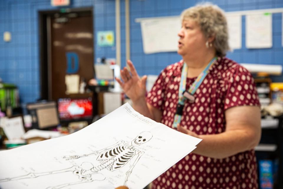 Students hand in worksheets to science teacher Cynthia Hopkins at Kaffie Middle School on Monday, Oct. 2, 2023, in Corpus Christi, Texas.
