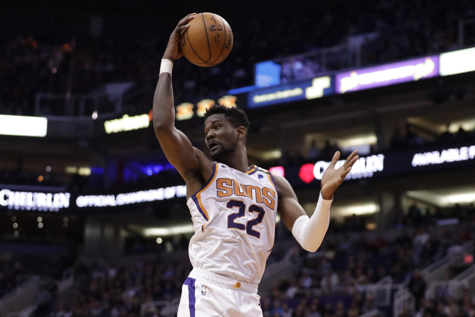 Phoenix Suns center Deandre Ayton (22) rebounds during the first half of an NBA basketball game against the Los Angeles Clippers, Wednesday, Feb. 26, 2020, in Phoenix. (AP Photo/Matt York)