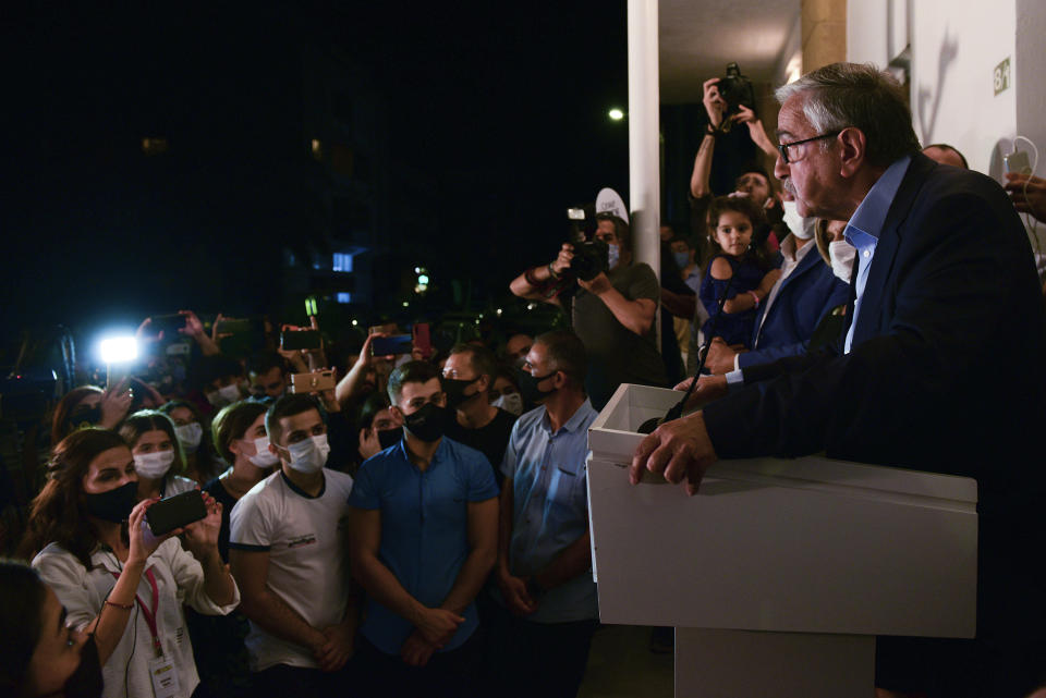 In this photo taken on Sunday, Oct. 11, 2020, Turkish Cypriot leader and candidate Mustafa Akinci addresses to his supporters after reaching the second round of the Turkish Cypriots election for a new leader in the Turkish occupied area in the north part of the divided capital Nicosia, Cyprus. Turkish Cypriots vote on Sunday Oct. 18, 2020 in a leadership runoff that could decide if they want to retain more control over their own affairs or steer even closer to an increasingly domineering Turkey. (AP Photo/Nedim Enginsoy)