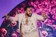 <p>John Legend gets down on Sept. 21 during his show at L.A.'s Greek Theatre. </p>
