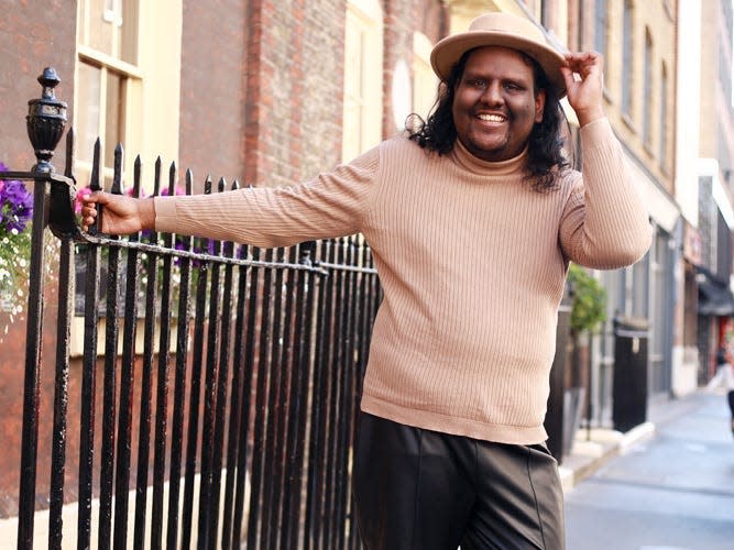 Dan hastings in a hat on a street