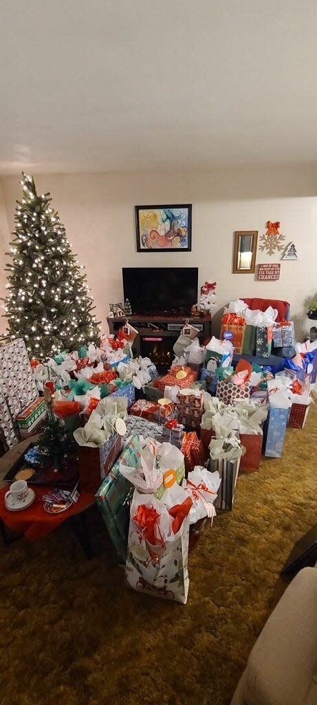 Justina Gorman of Canton fulfilled 75 Giving Tree tags at St. Michael Catholic Church with various presents that she purchased over the past year. It took Gorman and her family nearly eight hours wrapping the gifts. The Giving Tree is part of the parish's larger social justice outreach.