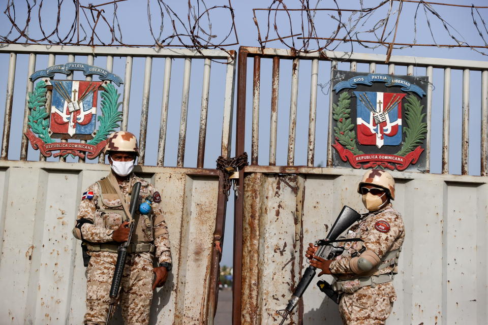 Haitian troops guard the bridge between the Dominican Republic and Haiti. The border was closed after the Haitian president's assassination July 8.