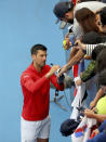 Serbia's Novak Djokovic signs autographs after defeating France's Quentin Halys during their Round of 16 match at the Adelaide International Tennis tournament in Adelaide, Australia, Thursday, Jan. 5, 2023. (AP Photo/Kelly Barnes)