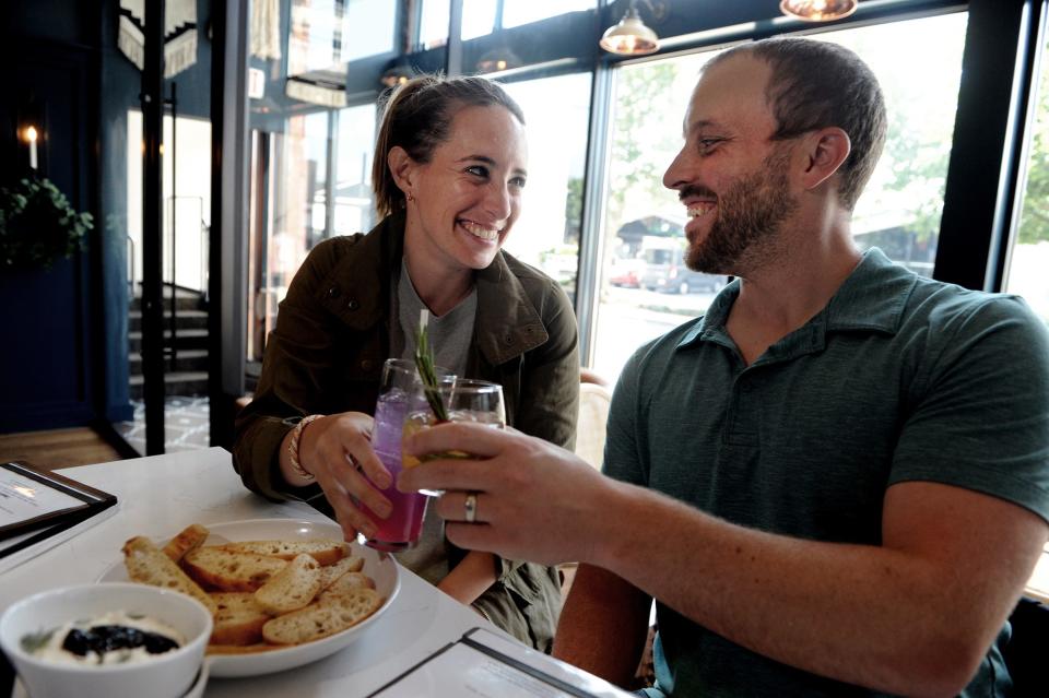 Diners Kelsey and Ben Campbell toast with drinks at 7 South Bottle and Kitchen in Natick, June 24, 2022.