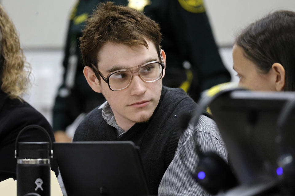 FILE - Marjory Stoneman Douglas High School shooter Nikolas Cruz is shown at the defense table during the penalty phase of his trial at the Broward County Courthouse in Fort Lauderdale, Fla., Friday, Sept. 2, 2022. Testimony at Cruz's trial shows that chaos reigned in the home he shared with his widowed mother and brother. Cruz pleaded guilty to murdering 17 students and staff members in 2018 at Marjory Stoneman Douglas High School in Parkland, Fla. The trial resumes Monday, Sept. 12, 2022. (Amy Beth Bennett/South Florida Sun-Sentinel via AP, Pool, File)