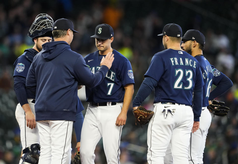 Seattle Mariners manager Scott Servais comes to the mound to remove starting pitcher Marco Gonzales during the seventh inning against the Milwaukee Brewers in a baseball game Wednesday, April 19, 2023, in Seattle. (AP Photo/Lindsey Wasson)