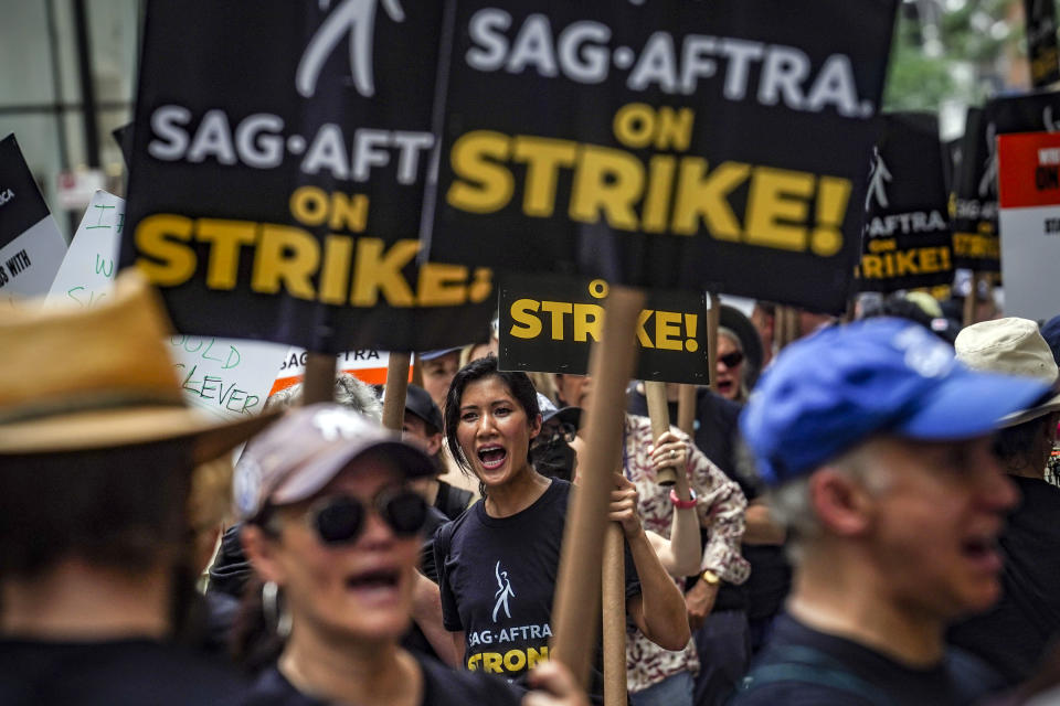 Striking writers and actors chant as they walk a picket line, Friday July 14, 2023, at NBC Universal Studios in New York. The picketing comes a day after the main actors’ union voted to join screenwriters in a double-barreled strike for the first time in more than six decades. The dispute immediately shut down production across the entertainment industry after talks for a new contract with studios and streaming services broke down. (AP Photo/Bebeto Matthews)