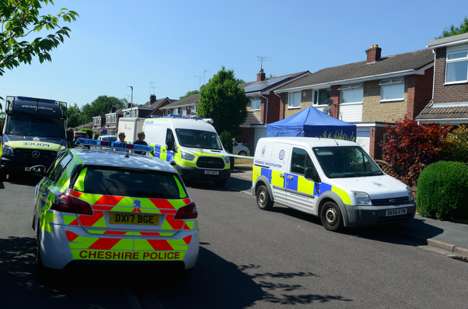 Detectives search a property on Tuesday (Picture: SWNS)