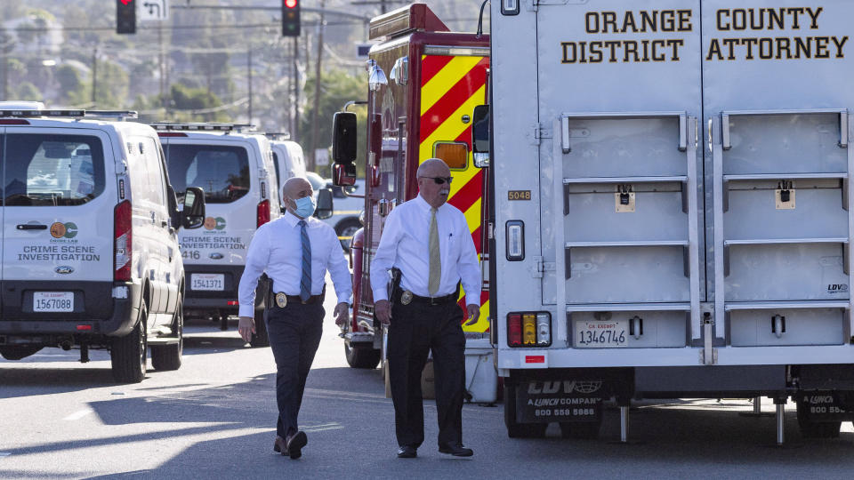 Officials work outside the scene of a shooting, Thursday, April 1, 2021 in Orange, Calif. The gunman who killed four people and wounded a fifth at an office complex knew all the victims either through business or personally, Southern California police said Thursday. (Paul Bersebach/The Orange County Register via AP)