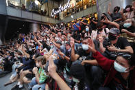 Pro-democracy demonstrators flash a three-finger salute of defiance during a protest rally at the Silom business district in Bangkok, Thailand, Thursday, Oct. 29, 2020. The protesters continue to gather Thursday with their three main demands of Prime Minister Prayuth Chan-ocha's resignation, changes to a constitution that was drafted under military rule and reforms to the constitutional monarchy. (AP Photo/Sakchai Lalit)