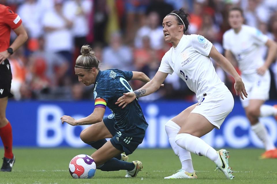 Germany&#39;s Svenja Huth, left, challenges England&#39;s Lucy Bronze for the ball during the Women&#39;s Euro 2022 final.