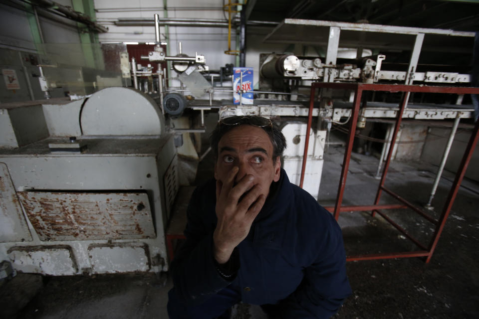 Bosnian man, Admir Becic, an employee of the detergent factory "Dita" looks on inside the factory in Bosnian town of Tuzla, 140 kms north of Sarajevo on Wednesday, Feb. 12, 2014. The violence engulfing Bosnia in recent days, with scenes of burning government buildings and protesters pelting police with stones, has many root causes. One of them is the failed privatizations of state-owned companies. (AP Photo/Amel Emric)