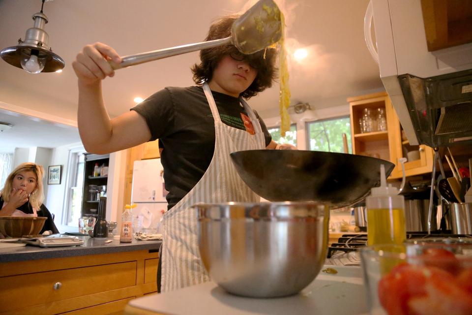 Alex Doane prepares an egg dish for breakfast at his Exeter home on Friday, July 15, 2022. His dad Kris Doane has created an online map where you can find fresh eggs for sale around the Seacoast.