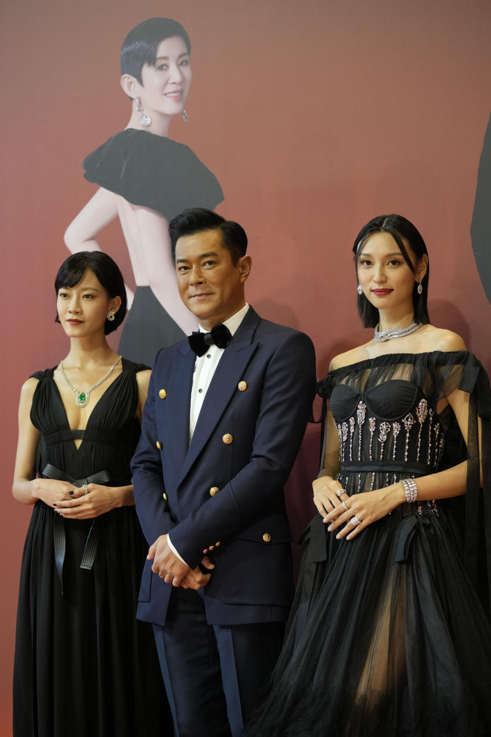 From Left, Hong Kong actress Fish Liew, actor Louis Koo and actress Louise Wong pose on red carpet at the Hong Kong Film Awards, Sunday, July 17, 2022. (AP Photo/Kin Cheung)