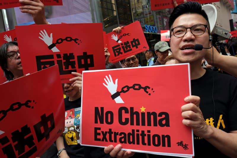 FILE PHOTO: Demonstrators march during a protest to demand authorities scrap a proposed extradition bill with China, in Hong Kong