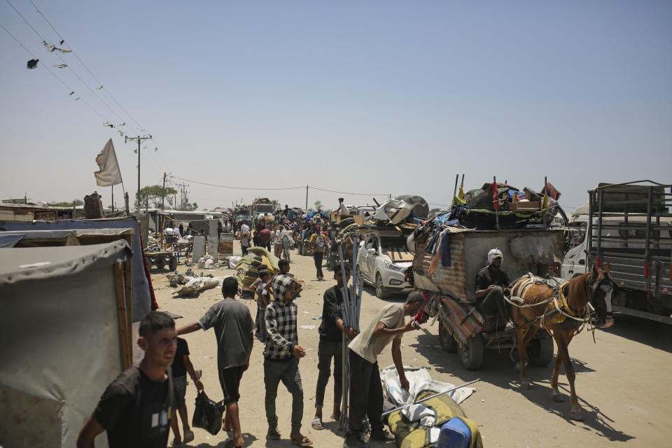 Palestinians arrive in the southern Gaza town of Khan Younis after fleeing an Israeli ground and air offensive in the nearby city of Rafah on Friday, June 28, 2024. (AP Photo/Jehad Alshrafi)