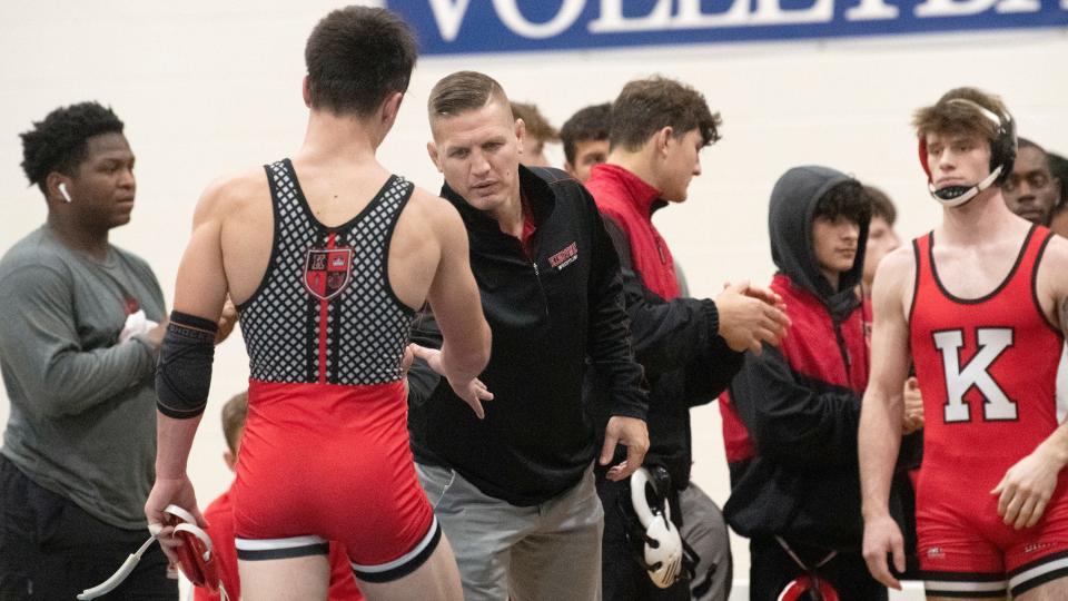 Kingsway's wrestling coach Mike Barikian, center,  congratulates Kingsway's Nathan Taylor after Taylor defeated St. Augustine's Borman, 19-3, during the 132 lb. bout of the wrestling meet held at St. Augustine Preparatory School in Richland on Wednesday, January 18, 2023.  