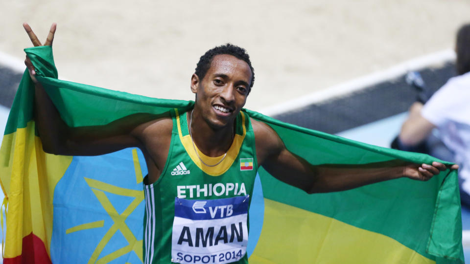 Ethiopia's Mohammed Aman carries the national flag after winning the men's 800m final during the Athletics World Indoor Championships in Sopot, Poland, Sunday, March 9, 2014. (AP Photo/Petr David Josek)