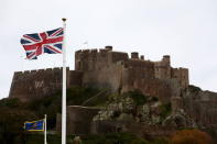 A union flag flies near Mont Orgueil Castle at Gorey Harbour in Jersey in this November 12, 2012 file photo. REUTERS/Stefan Wermuth/Files