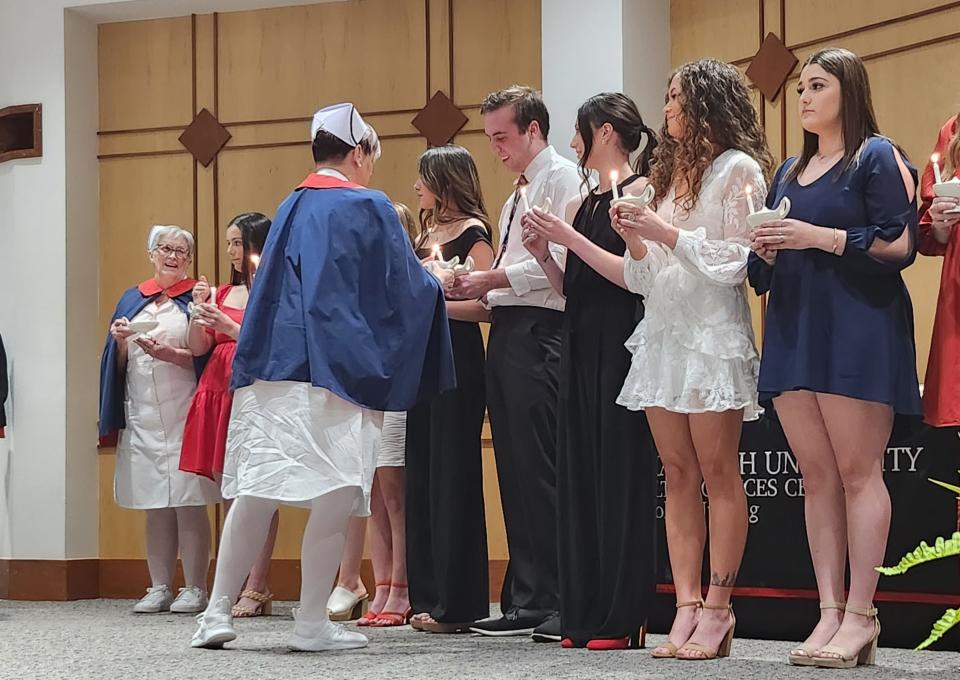 Students make the Florence Nightingale pledge with ceremonial lamp lighting as the first graduating class of the Texas Tech University Health Sciences Center (TTUHSC) School of Nursing in Amarillo on Thursday at the TTUHSC Jerry H. Hodge School of Pharmacy Harrington Auditorium.