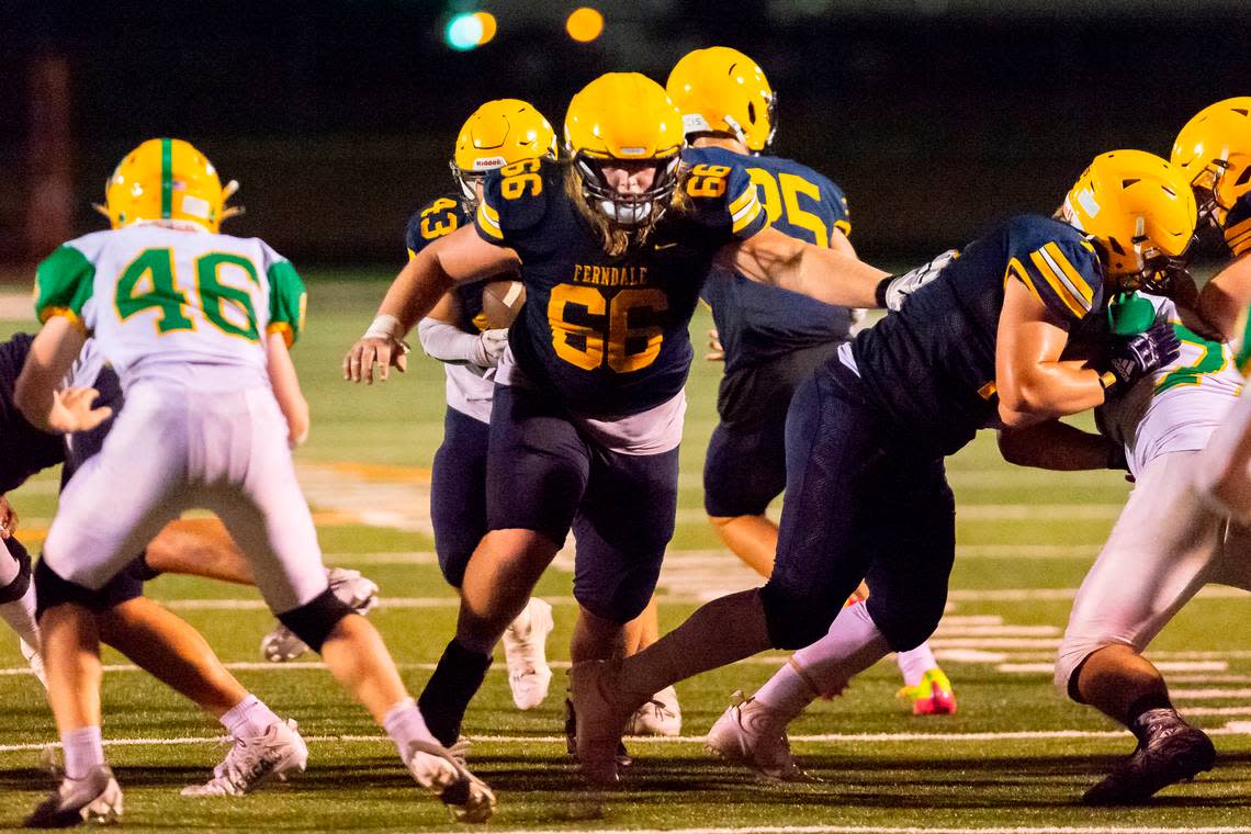 Ferndale offensive lineman Landen Hatchett (66) clears a path for running back Jason Nowak (43) during the third quarter on Friday evening Sept. 2, 2022, at Blaine High School in Blaine, Wash. Lynden defeated Ferndale 24 to 7 in their season opener.