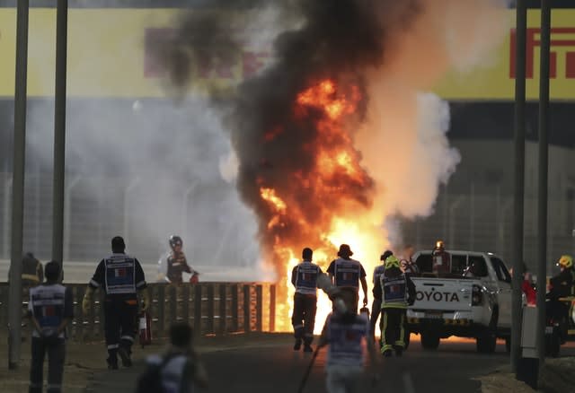 Marshals run to extinguish Romain Grosjean’s car