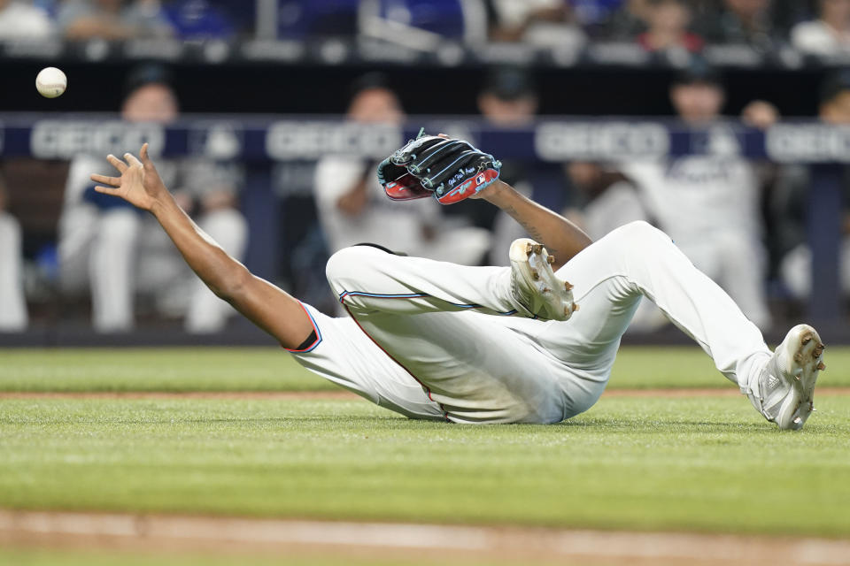 Miami Marlins starting pitcher Edward Cabrera falls to the field as he attempts to throw on a bunt by Washington Nationals' Victor Robles during the fourth inning of a baseball game, Sunday, Sept. 25, 2022, in Miami.(AP Photo/Lynne Sladky)