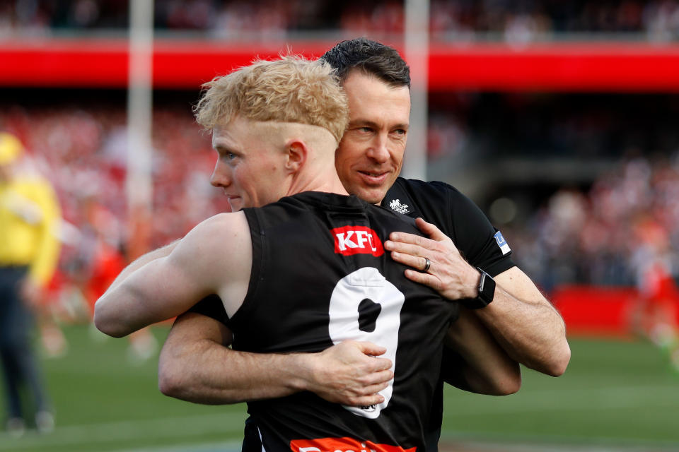 Craig McRae hugs John Noble after the loss to the Sydney Swans at the SCG.