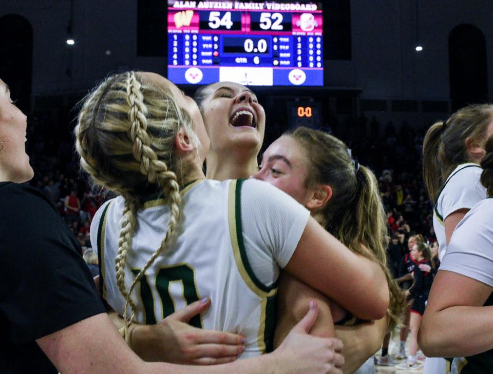 Archbishop Wood's Sophia Topakas (10), Emily Knouse (30), and Ava Renninger (4) hug as they celebrate their win over Archbishop Carroll after going into double overtime during the Philadelphia Catholic League girls' basketball championship game in Philadelphia on Monday, Feb. 26, 2024.