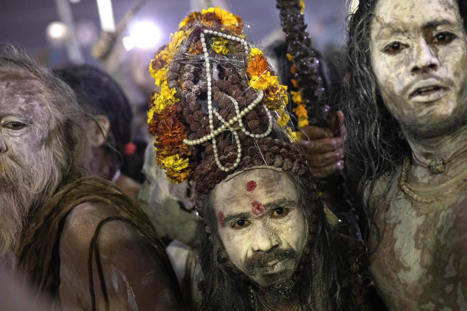 Indian Sadhus, or Hindu holy men, covered in ash walk before taking a ritualistic dip on auspicious Makar Sankranti day during the Kumbh Mela, or pitcher festival in Prayagraj, Uttar Pradesh state, India, Tuesday, Jan.15, 2019. The Kumbh Mela is a series of ritual baths by Hindu holy men, and other pilgrims at the confluence of three sacred rivers the Yamuna, the Ganges and the mythical Saraswati that dates back to at least medieval times. The city's Mughal-era name Allahabad was recently changed to Prayagraj. (AP Photo/Bernat Armangue)