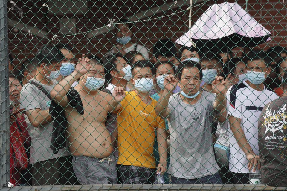 Residents wait in line for the coronavirus test in a district in Guangzhou in southern China's Guangdong province on Sunday, May 30, 2021. The southern Chinese city of Guangzhou shut down a neighborhood and ordered residents to stay home Saturday to be tested for the coronavirus following an upsurge in infections that has rattled authorities. (AP Photo)