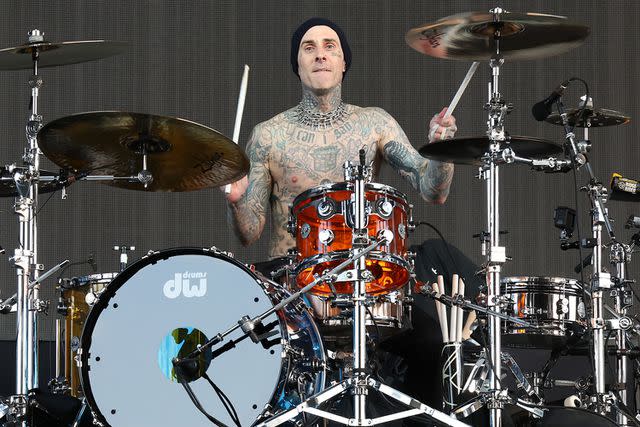 <p>Monica Schipper/Getty</p> Travis Barker performs in Indio California in April 2023