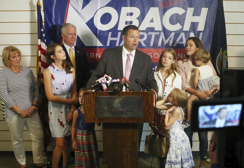 Secretary of State Kris Kobach, surrounded by his family and running mate Wink Hartman, talked to the media during a news conference at the Topeka Capitol Plaza hotel in Topeka, Kan., Wednesday, Aug. 8, 2018. (Thad Allton /The Topeka Capital-Journal via AP)