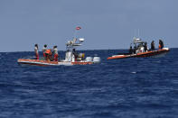 Scuba divers of the Italian Firefighters corp at the scene of the search for a missing boat, in Porticello, southern Italy, Wednesday, Aug. 21, 2024. Rescue teams and divers returned to the site of a storm-sunken superyacht Tuesday to search for six people, including British tech magnate Mike Lynch, who are believed to be still trapped in the hull 50 meters (164-feet) underwater. (AP Photo/Salvatore Cavalli)