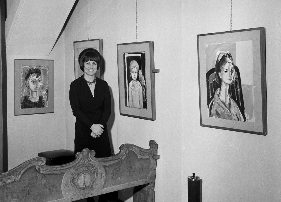FILE - Artist Francois Gilot poses with her work at a personal art exhibition in Milan, Dec. 21, 1965. Gilot, a prolific and acclaimed painter who produced art for well more than a half-century but was nonetheless more famous for her turbulent relationship with Pablo Picasso — and for leaving him — died Tuesday, June 6, 2023, in New York, where she had lived for decades. She was 101. (AP Photo, File)