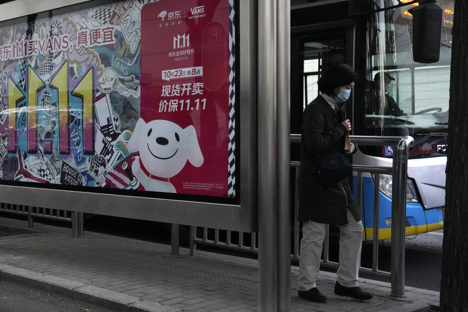 A resident passes an advertisement for Singles' Day in Beijing, Wednesday, Nov. 8, 2023. Shoppers in China have been tightening their purse strings, raising questions over how faltering consumer confidence may affect the annual Singles' Day online retail extravaganza. (AP Photo/Ng Han Guan)