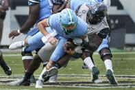 Central Florida defensive lineman Kenny Turnier, right, sacks Tulane quarterback Michael Pratt, left, during the first half of an NCAA college football game, Saturday, Oct. 24, 2020, in Orlando, Fla. (AP Photo/John Raoux)