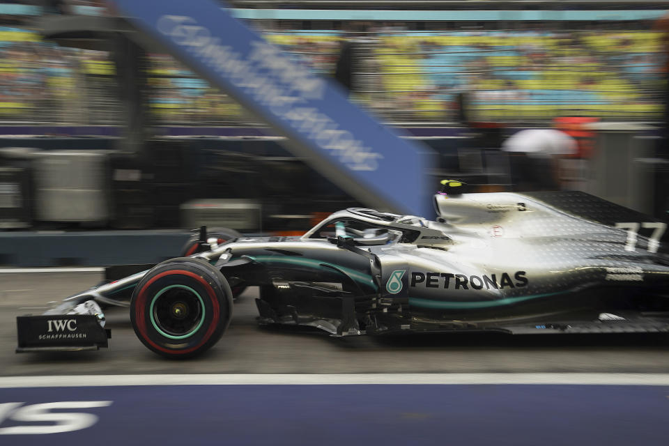 Mercedes driver Valtteri Bottas of Finland steers his car out of the pit-lane during the first practice session at the Marina Bay City Circuit ahead of the Singapore Formula One Grand Prix in Singapore, Friday, Sept. 20, 2019. (AP Photo/Vincent Thian)