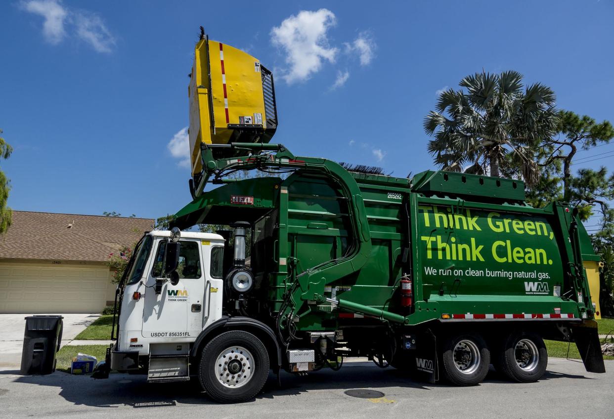 Ludes Joseph collects trash for Waste Management using a semi-automated claw and bin system in Wellington on July 26, 2018.