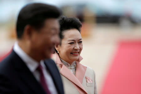 FILE PHOTO: Chinese President Xi Jinping and with his wife Peng Liyuan smile during a welcoming ceremony in Belgrade, Serbia June 18, 2016. REUTERS/Marko Djurica/File Photo