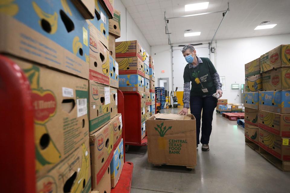 Every $1 donated to Central Texas Food Bank provides eight meals for those in need. In this February 2022 photo, Susan Lokken, volunteer leader, prepares boxes for distribution.