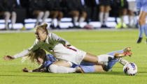 Florida State's Beata Olsson (9) falls onto North Carolina's Tori Hansen during the first half of an NCAA women's soccer tournament semifinal in Cary, N.C., Friday, Dec. 2, 2022. (AP Photo/Ben McKeown)