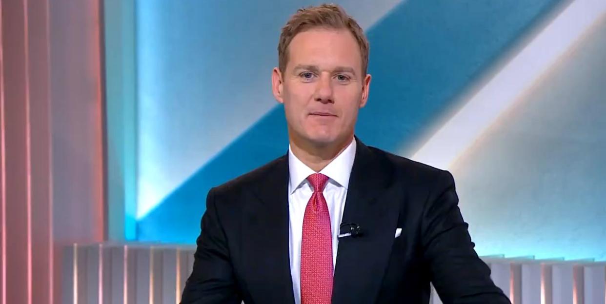 dan walker in a suit and tie presenting 5 news