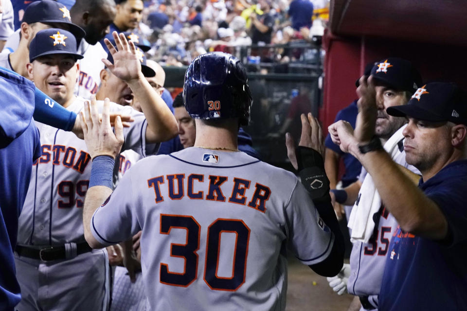 Houston Astros' Kyle Tucker celebrates his run scored against the Arizona Diamondbacks during the fourth inning of a baseball game, Saturday, Sept. 30, 2023, in Phoenix. (AP Photo/Ross D. Franklin)