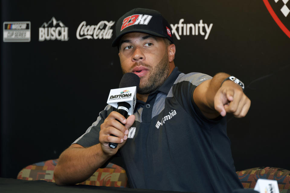 Bubba Wallace answers a question from a reporter during a media availability before a NASCAR Cup Series auto race at Daytona International Speedway, Friday, Aug. 26, 2022, in Daytona Beach, Fla. (AP Photo/Terry Renna)