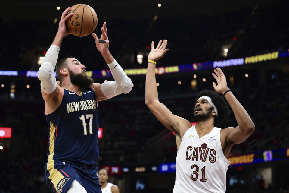 New Orleans Pelicans center Jonas Valanciunas (17) goes to the basket against Cleveland Cavaliers center Jarrett Allen (31) in the second half of an NBA basketball game, Thursday, Dec. 21, 2023, in Cleveland. (AP Photo/David Dermer)