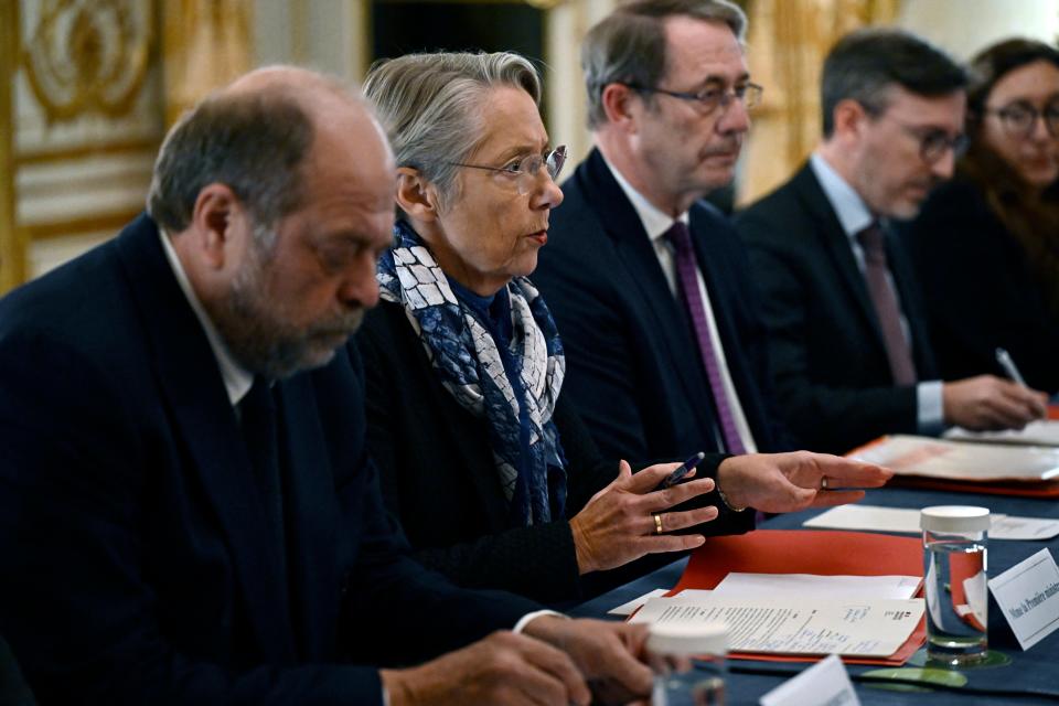 French Prime Minister Elisabeth Borne (2nd from left) presides at a meeting at the Matignon Hotel a day after one person was killed and two others wounded in a knife attack in Paris on December 3, 2023.