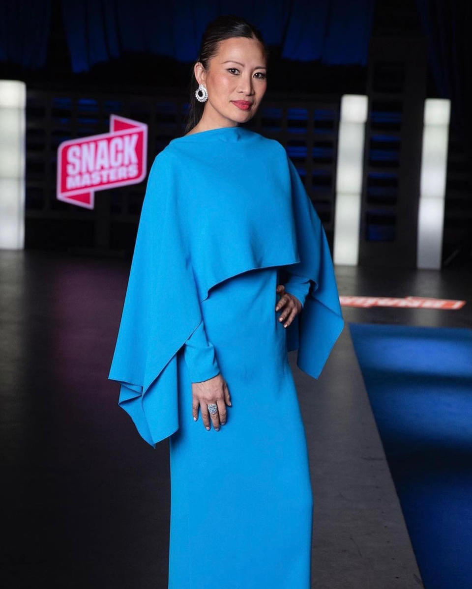 Poh Ling Yeow on the set of Snackmasters in a blue dress